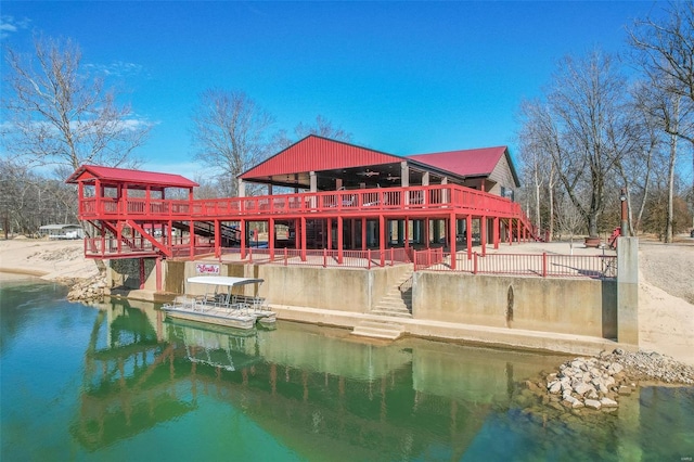 rear view of property with a water view