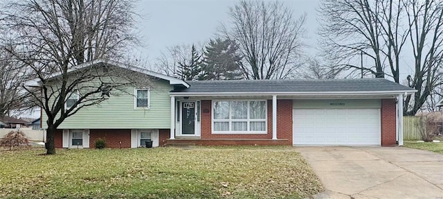 tri-level home featuring a garage and a front lawn