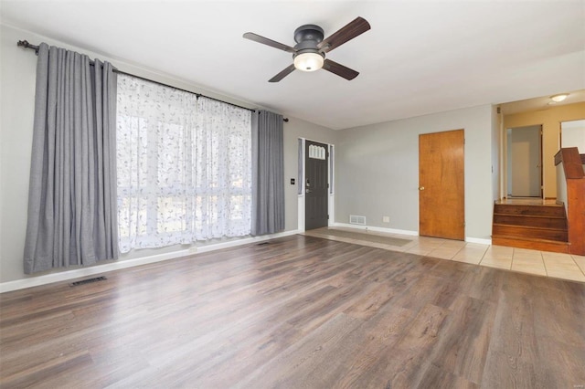 spare room with ceiling fan and light wood-type flooring