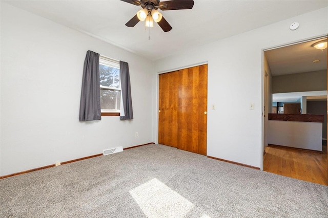 unfurnished bedroom with ceiling fan, a closet, and carpet