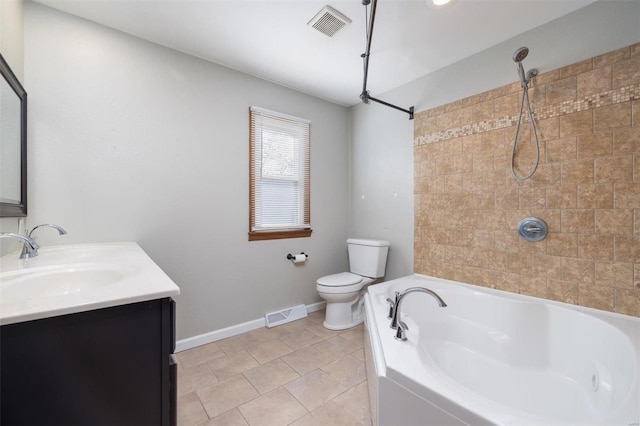 bathroom featuring tile patterned flooring, vanity, a bathtub, and toilet