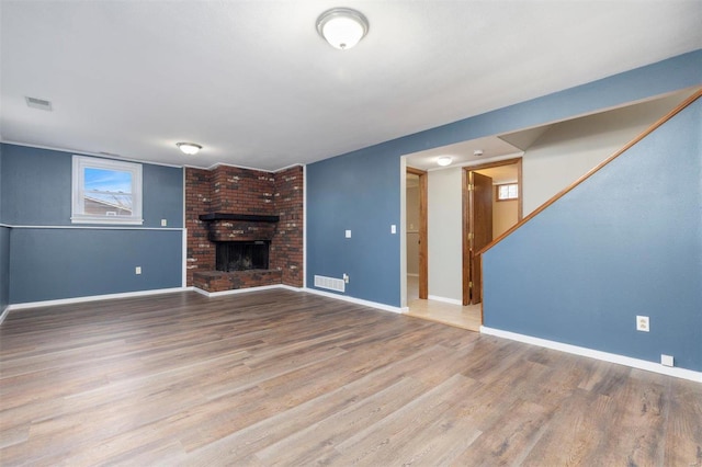 unfurnished living room featuring a fireplace and light wood-type flooring