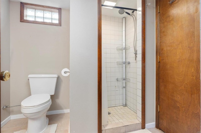 bathroom with tiled shower and toilet