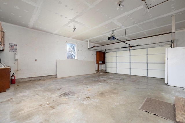 garage with white refrigerator and a garage door opener