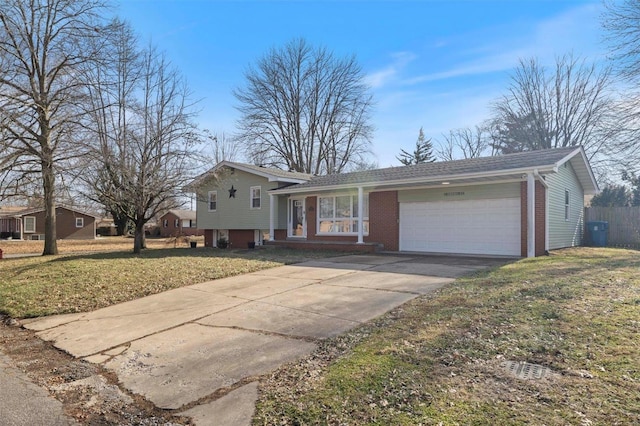 tri-level home with a garage and a front lawn