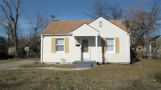 bungalow-style house with a front yard