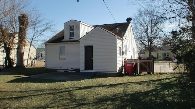 rear view of property with a yard and a patio