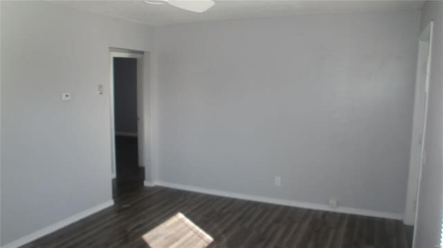 unfurnished room featuring dark hardwood / wood-style floors