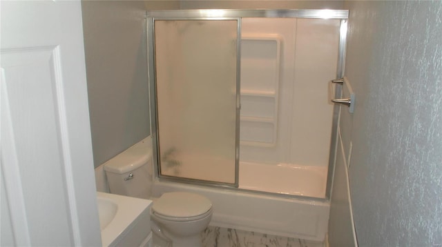 full bathroom with vanity, bath / shower combo with glass door, and toilet