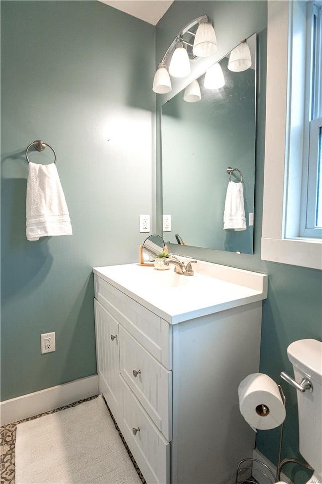 bathroom featuring vanity and toilet