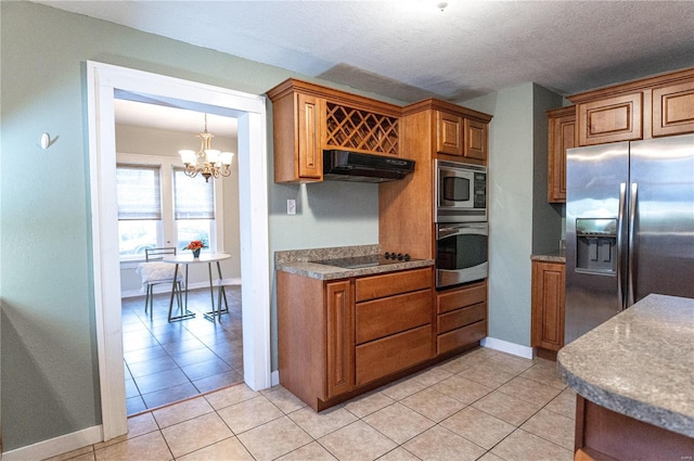 kitchen featuring light tile patterned floors, appliances with stainless steel finishes, a textured ceiling, decorative light fixtures, and a chandelier