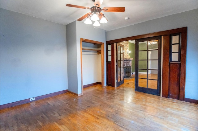 spare room with hardwood / wood-style flooring and ceiling fan