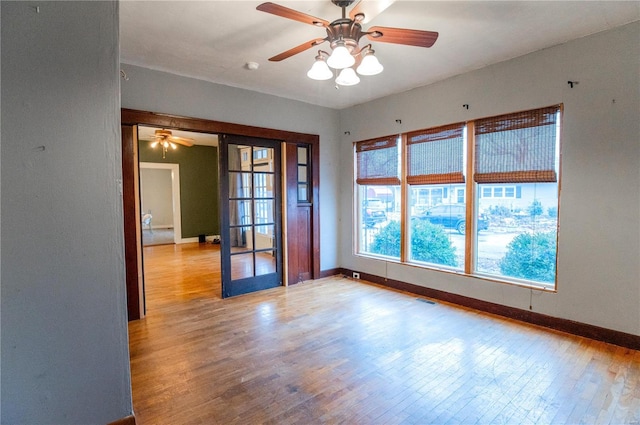 spare room with light hardwood / wood-style flooring and ceiling fan