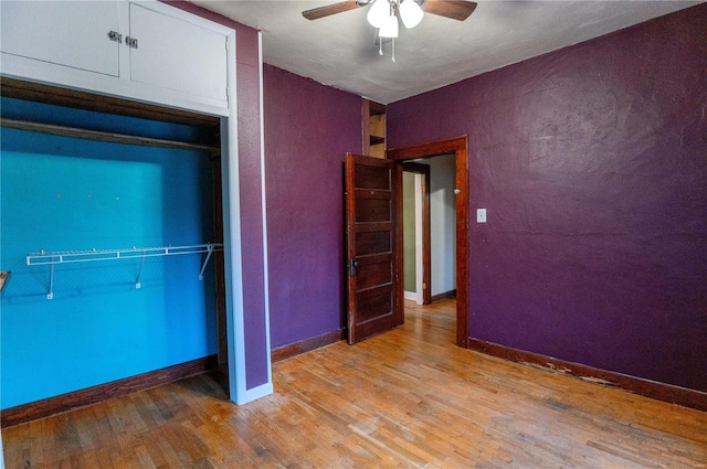 unfurnished bedroom featuring ceiling fan, a closet, and light hardwood / wood-style flooring