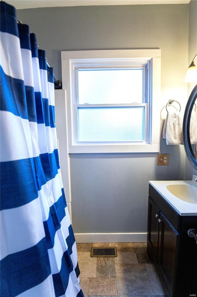 bathroom with vanity and plenty of natural light