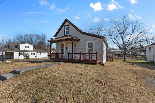 view of front of house with covered porch and a front yard