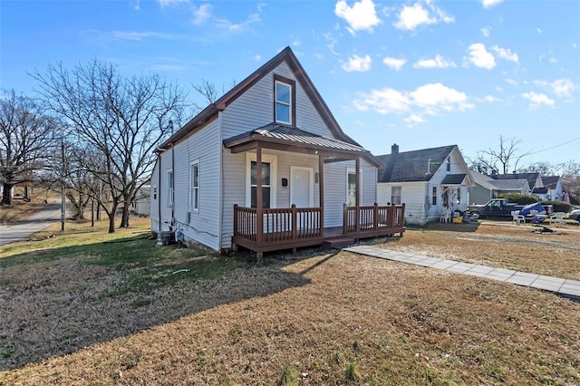 bungalow-style house featuring a front lawn and covered porch