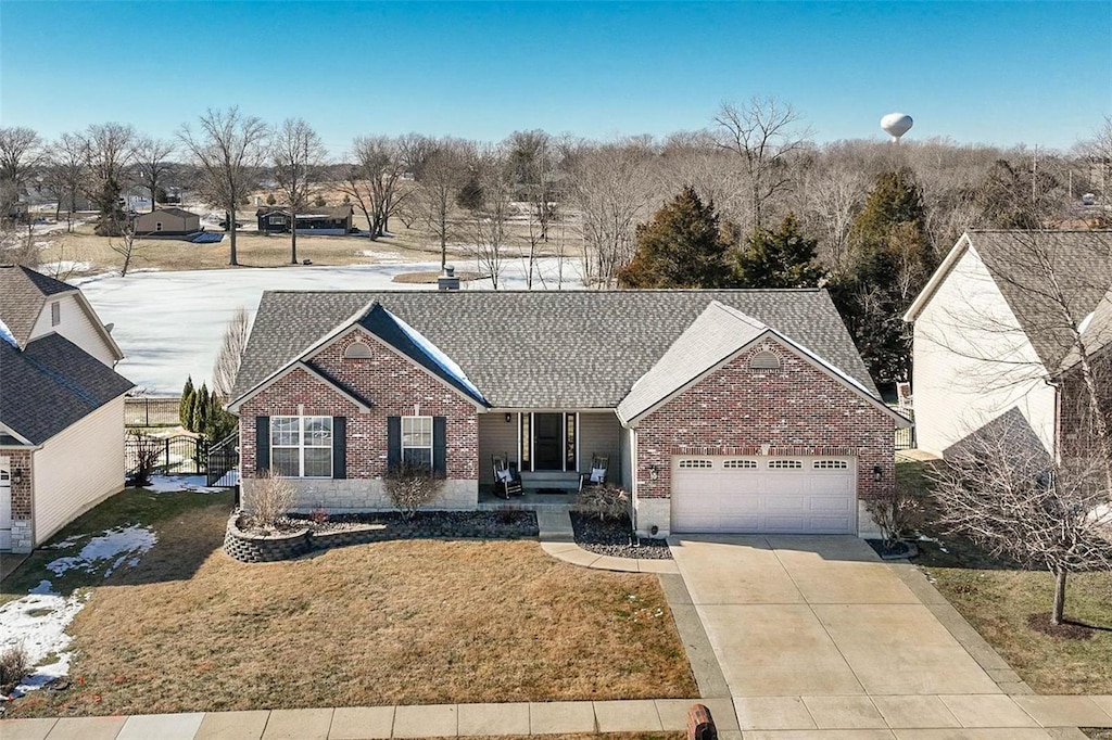 view of front of property with a garage and a front yard