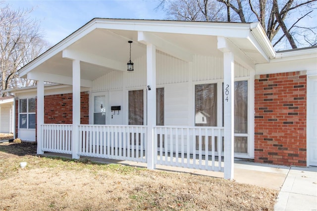 view of home's exterior with a porch and brick siding