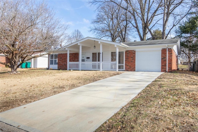 single story home with a garage, covered porch, driveway, and brick siding