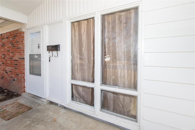 property entrance featuring brick siding