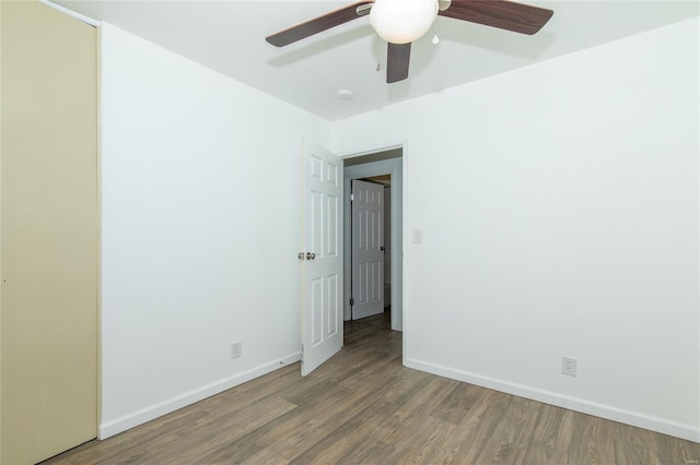 unfurnished room with a ceiling fan, baseboards, and wood finished floors