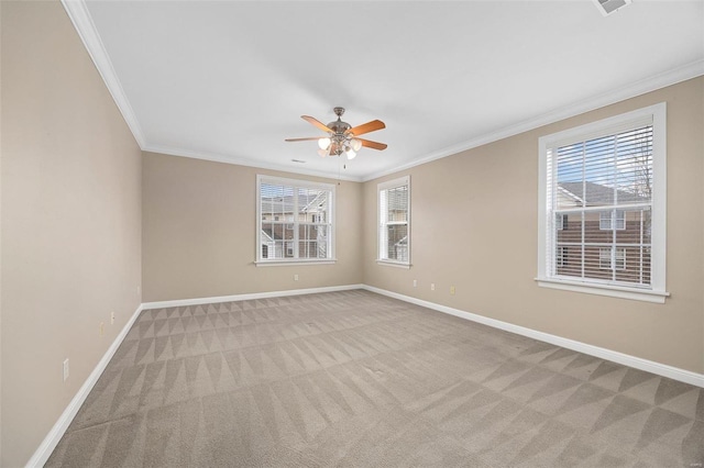 carpeted spare room with crown molding, a healthy amount of sunlight, and ceiling fan