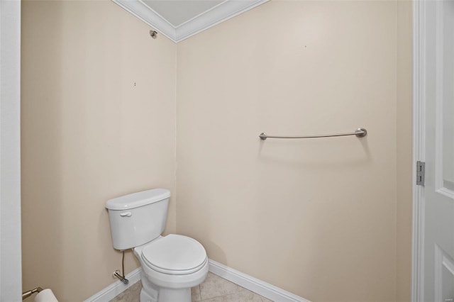 bathroom with tile patterned flooring, crown molding, and toilet