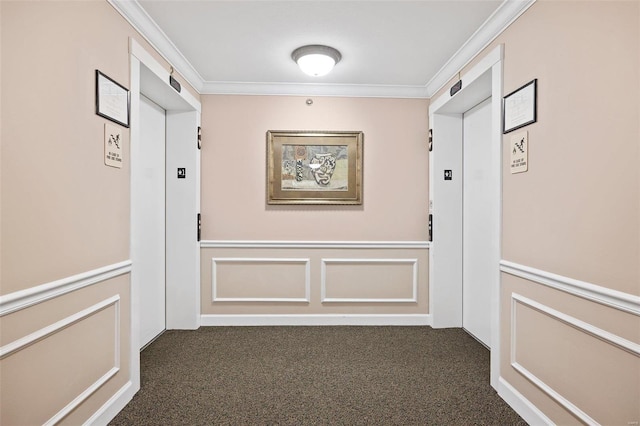 hallway with crown molding, elevator, and dark colored carpet