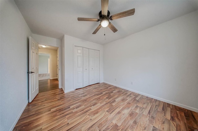 unfurnished bedroom with a closet, ceiling fan, and light hardwood / wood-style flooring