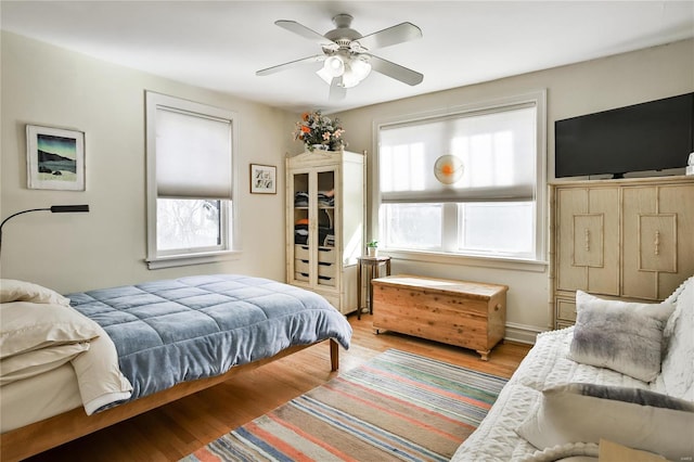 bedroom with light wood-style floors and a ceiling fan