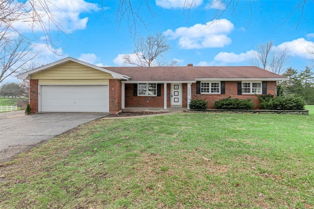 single story home featuring a garage and a front yard