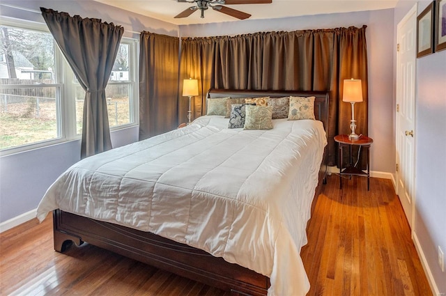 bedroom with wood-type flooring and multiple windows