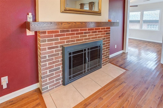 interior details featuring wood-type flooring and a fireplace