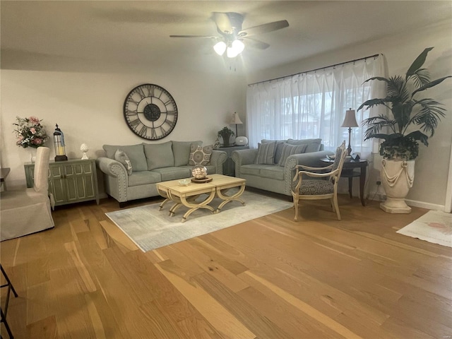 living room featuring ceiling fan and light wood-type flooring