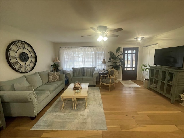 living room featuring light hardwood / wood-style floors and ceiling fan