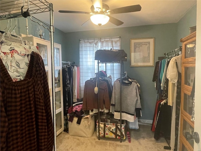 spacious closet with ceiling fan and light carpet