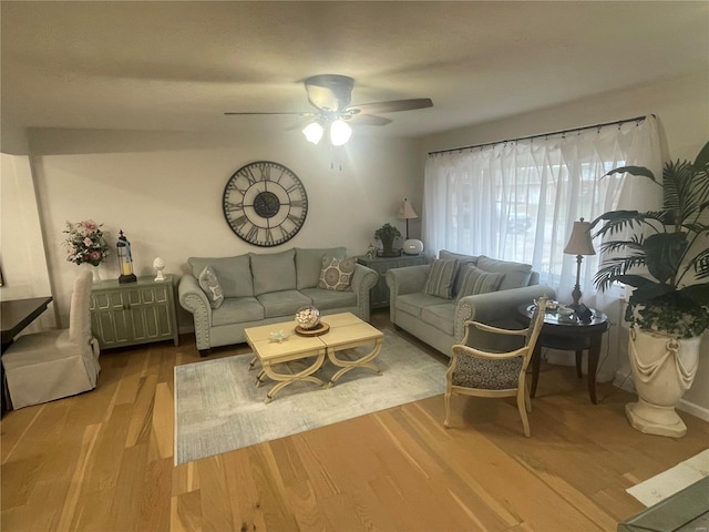 living room with ceiling fan and light hardwood / wood-style flooring