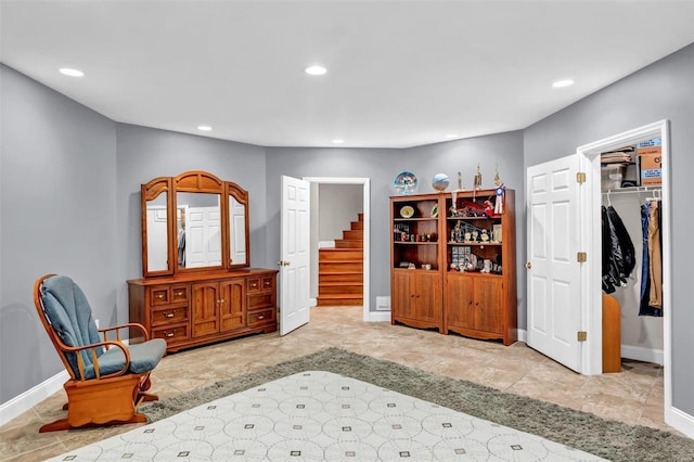 bedroom featuring a spacious closet, ensuite bath, and a closet