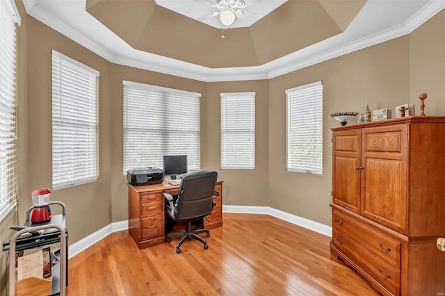 office area with ornamental molding, a raised ceiling, and light hardwood / wood-style floors