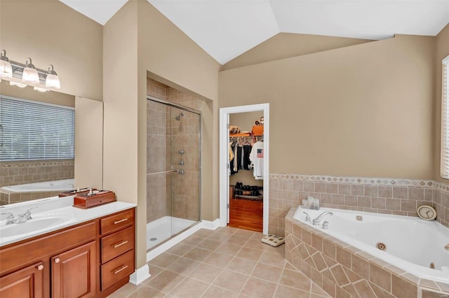 bathroom featuring lofted ceiling, vanity, tile patterned floors, and shower with separate bathtub