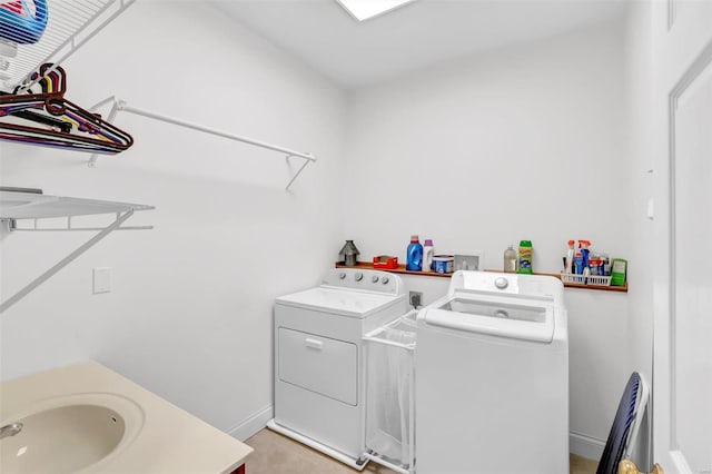 clothes washing area with sink and washing machine and dryer