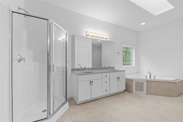 bathroom featuring vanity, a skylight, tile patterned floors, and shower with separate bathtub