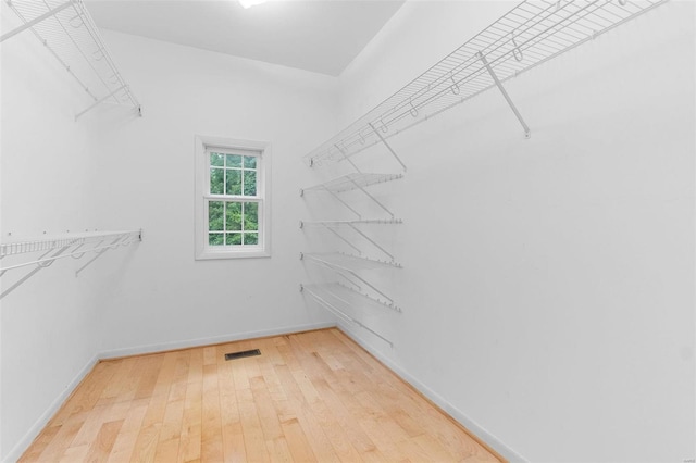 spacious closet featuring hardwood / wood-style flooring