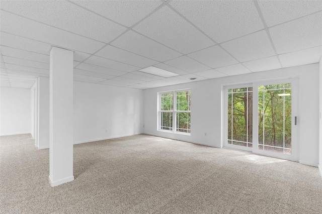 carpeted spare room with a paneled ceiling