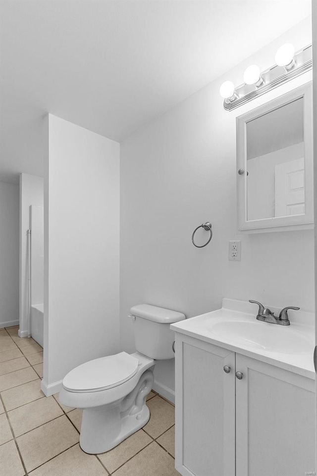 bathroom with tile patterned flooring, vanity, a bath, and toilet