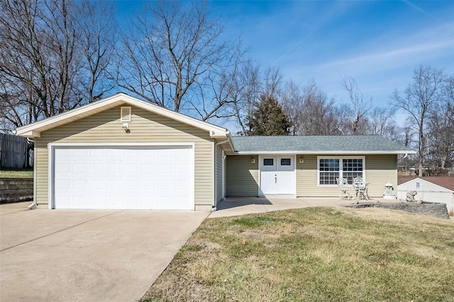 ranch-style home with a garage and a front yard