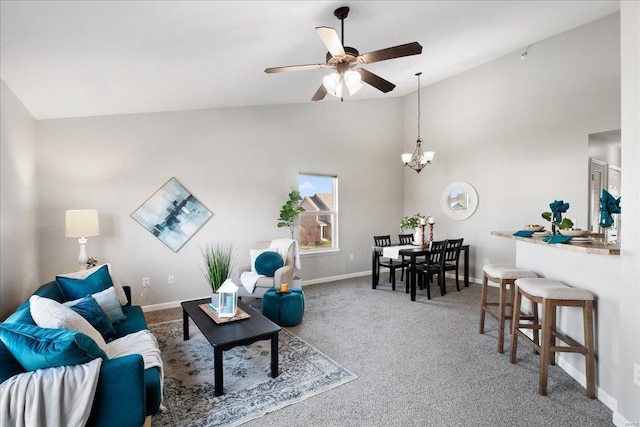 living room with ceiling fan with notable chandelier, high vaulted ceiling, and carpet floors