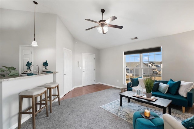 living room with dark wood-type flooring, ceiling fan, and high vaulted ceiling