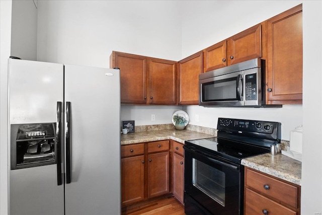 kitchen with appliances with stainless steel finishes and light wood-type flooring